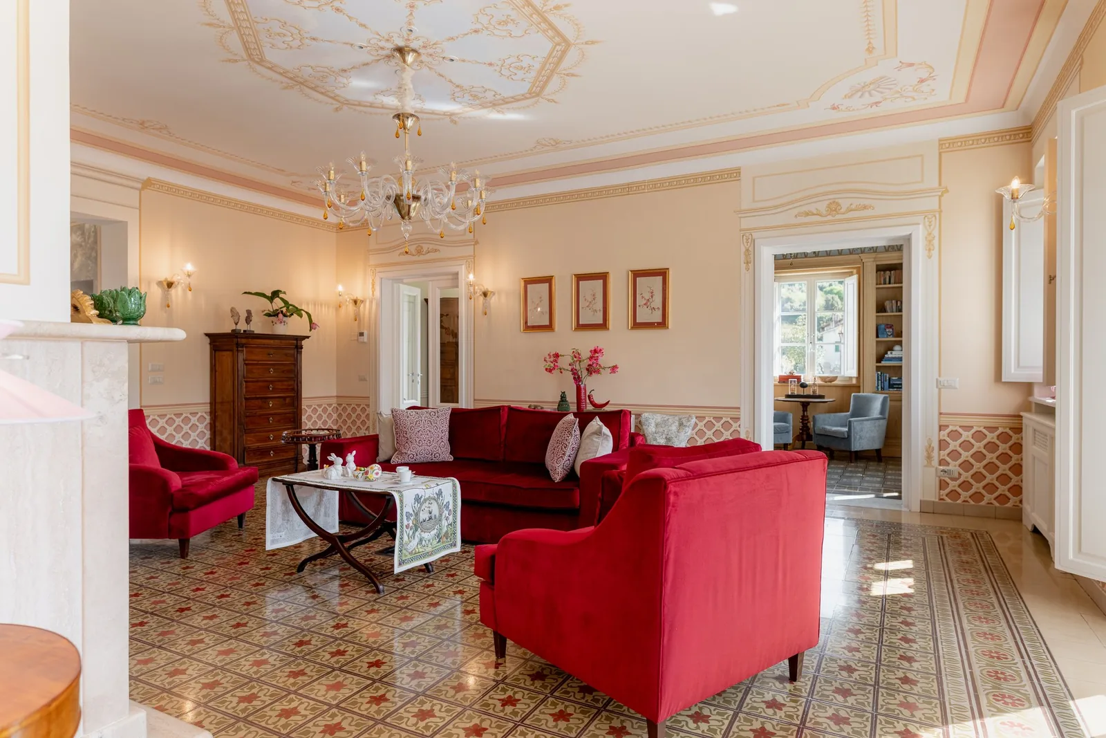 Salon de réception de Villa Marie avec fauteuils rouges et cheminée