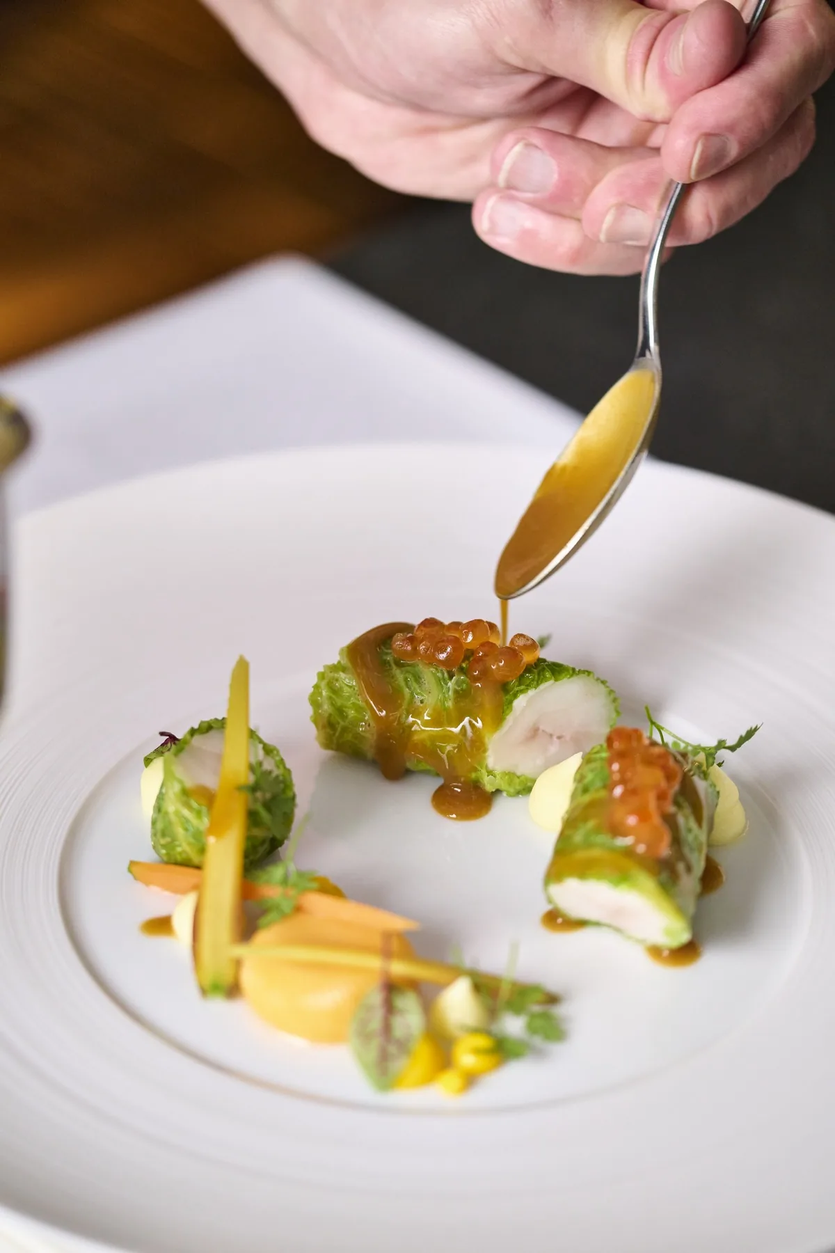 Villa Marie chef finishing a seasonal fish course