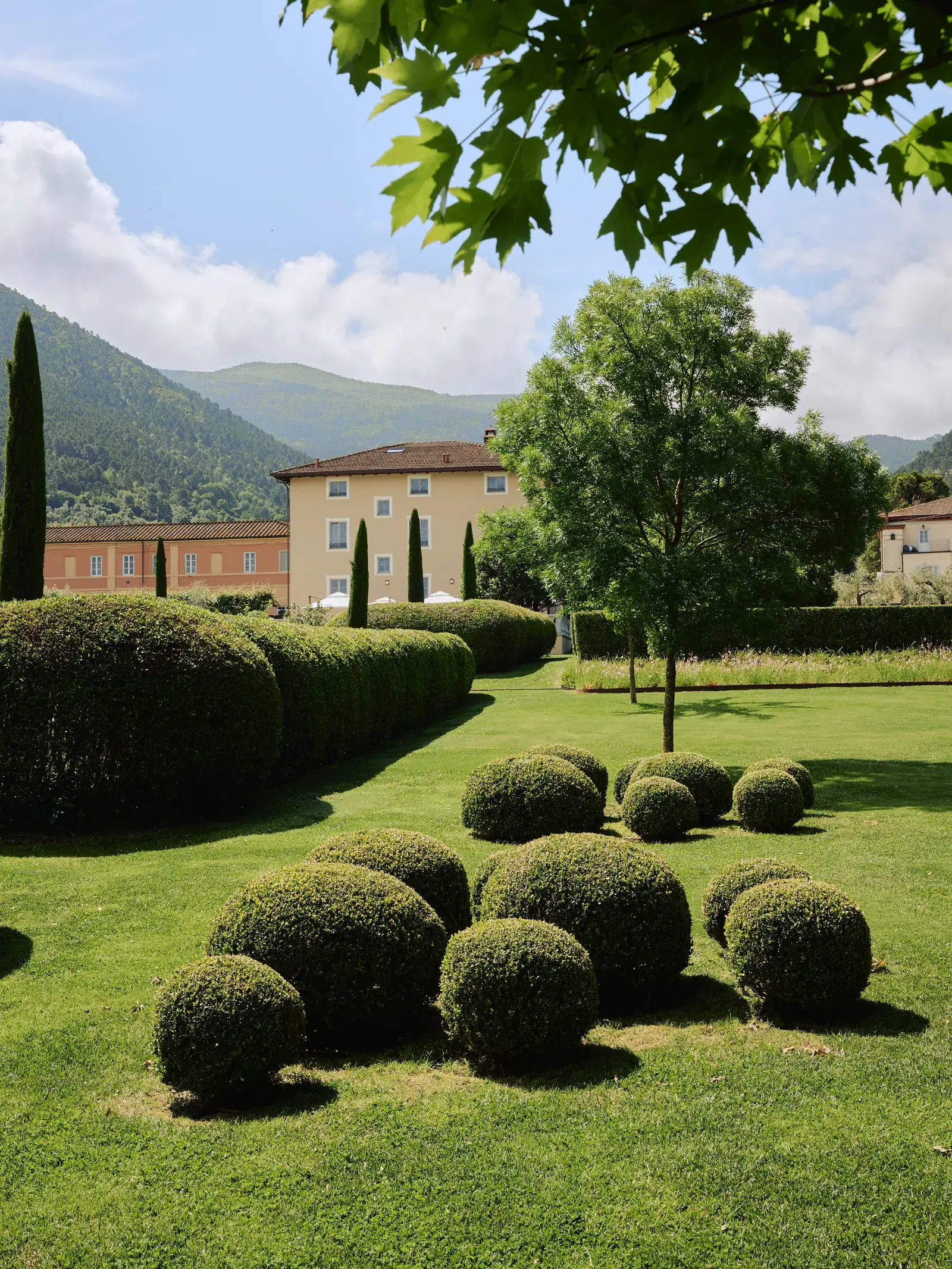 Manicured gardens surrounding the main villa in Tuscany