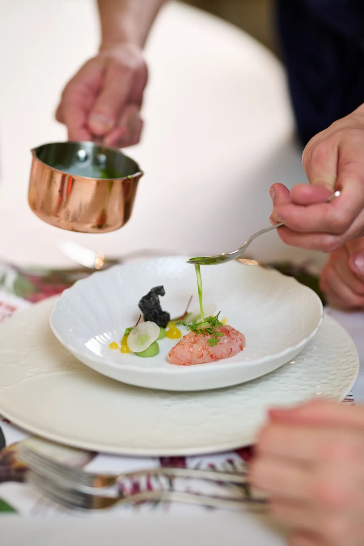 Private chef finishing a tasting menu course at Villa Marie