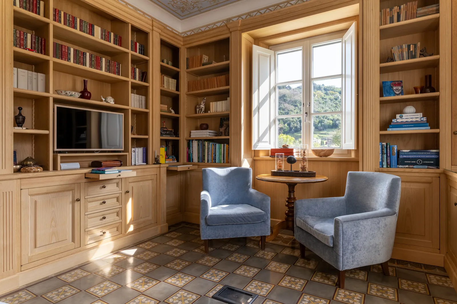 Wood-panelled library and reading room at Villa Marie